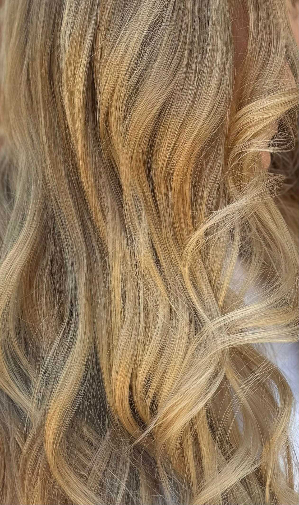 a zoomed in photo of blonde hair with bright blonde highlighting